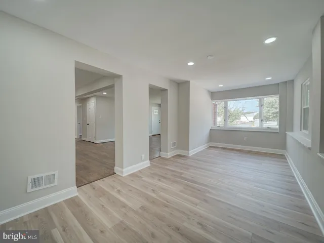 a bathroom with a tub sink toilet and a mirror