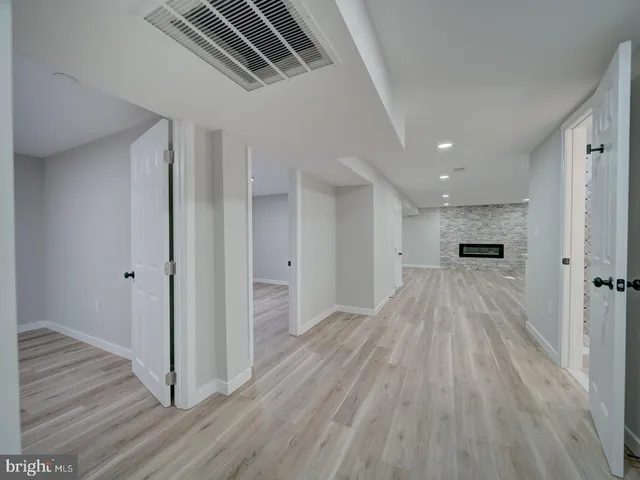 a view of an empty room and wooden floor