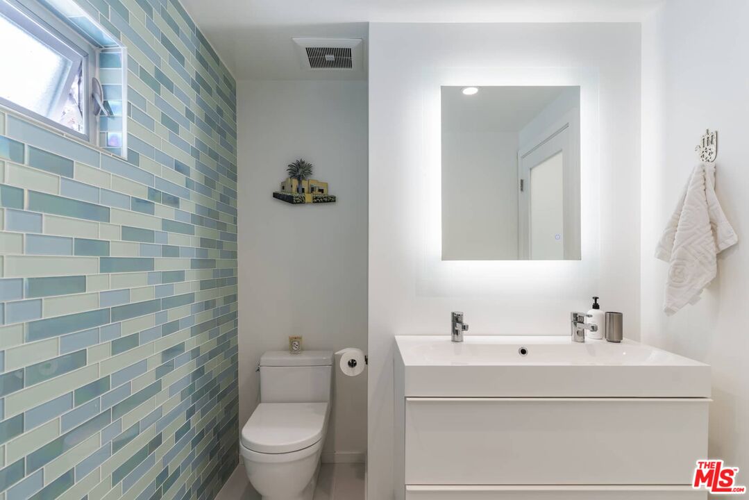 29 Paradise Cove Road Malibu, CA 90265 - Photo 13 of 33 a bathroom with a sink and mirror with toilet