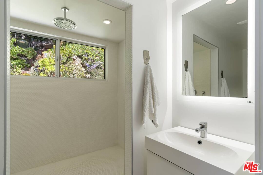 29 Paradise Cove Road Malibu, CA 90265 - Photo 16 of 33 a bathroom with a sink a window and a mirror