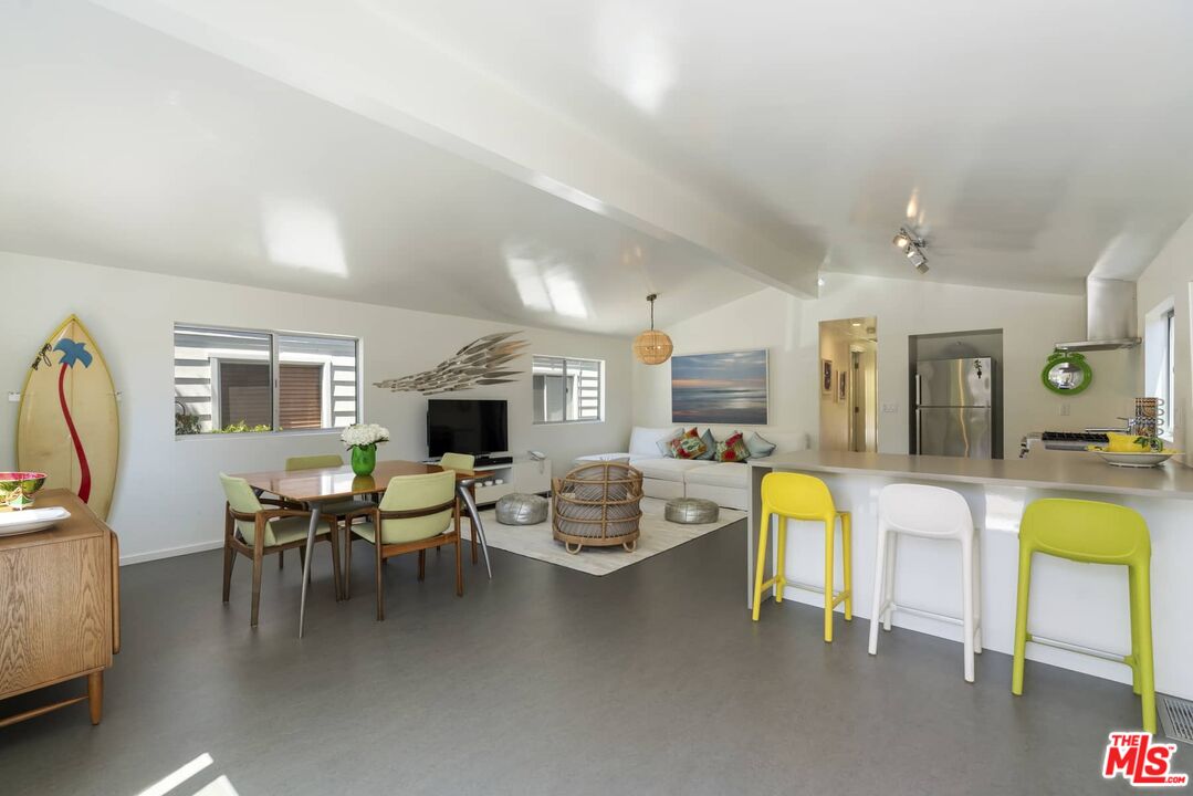 29 Paradise Cove Road Malibu, CA 90265 - Photo 6 of 33 a dining room with furniture and a flat screen tv