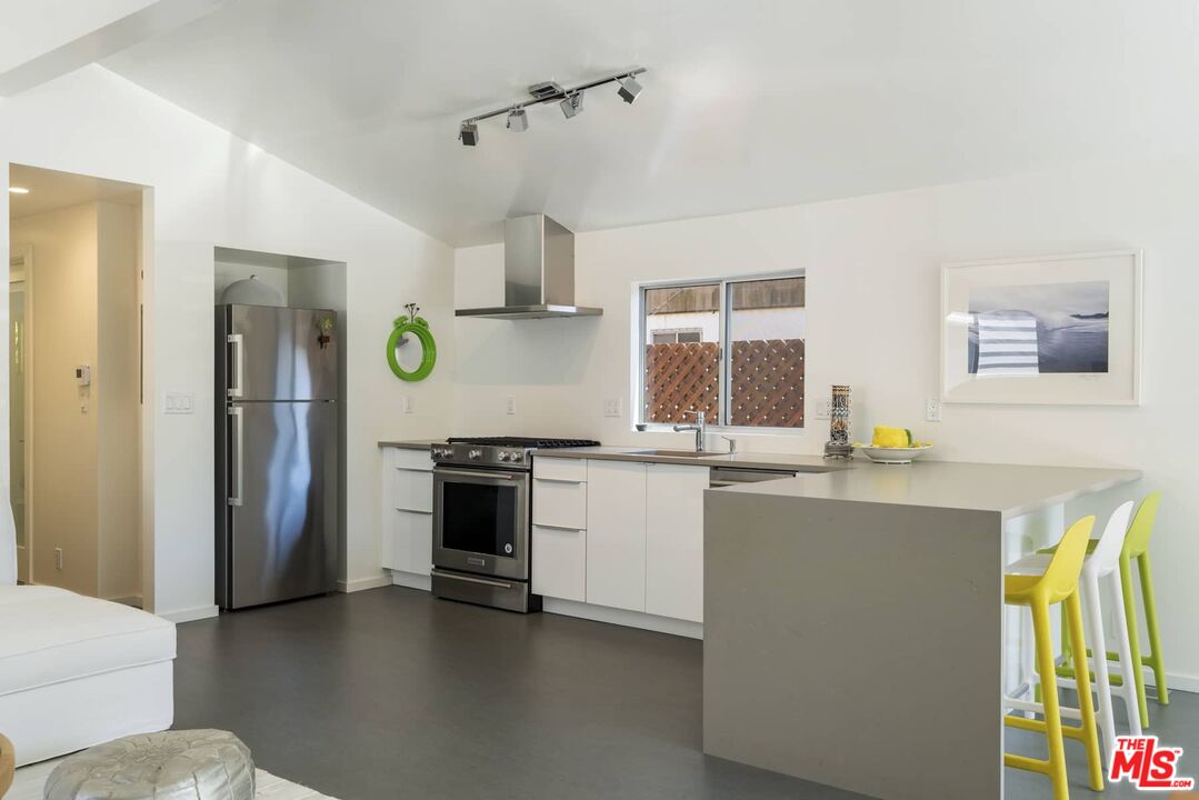 29 Paradise Cove Road Malibu, CA 90265 - Photo 8 of 33 a kitchen with a sink stove and refrigerator