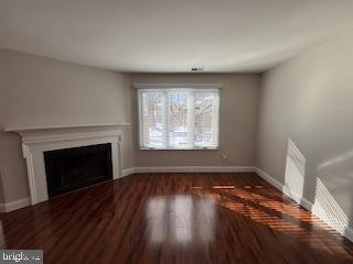 338 Dorset Court Doylestown, PA 18901 - Photo 3 of 27 an empty room with wooden floor fireplace and windows