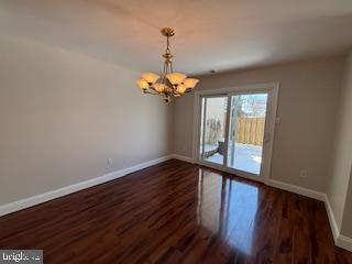 338 Dorset Court Doylestown, PA 18901 - Photo 6 of 27 a view of a room with wooden floor and chandelier