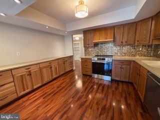 338 Dorset Court Doylestown, PA 18901 - Photo 9 of 27 a kitchen with stainless steel appliances granite countertop wooden floors and white cabinets