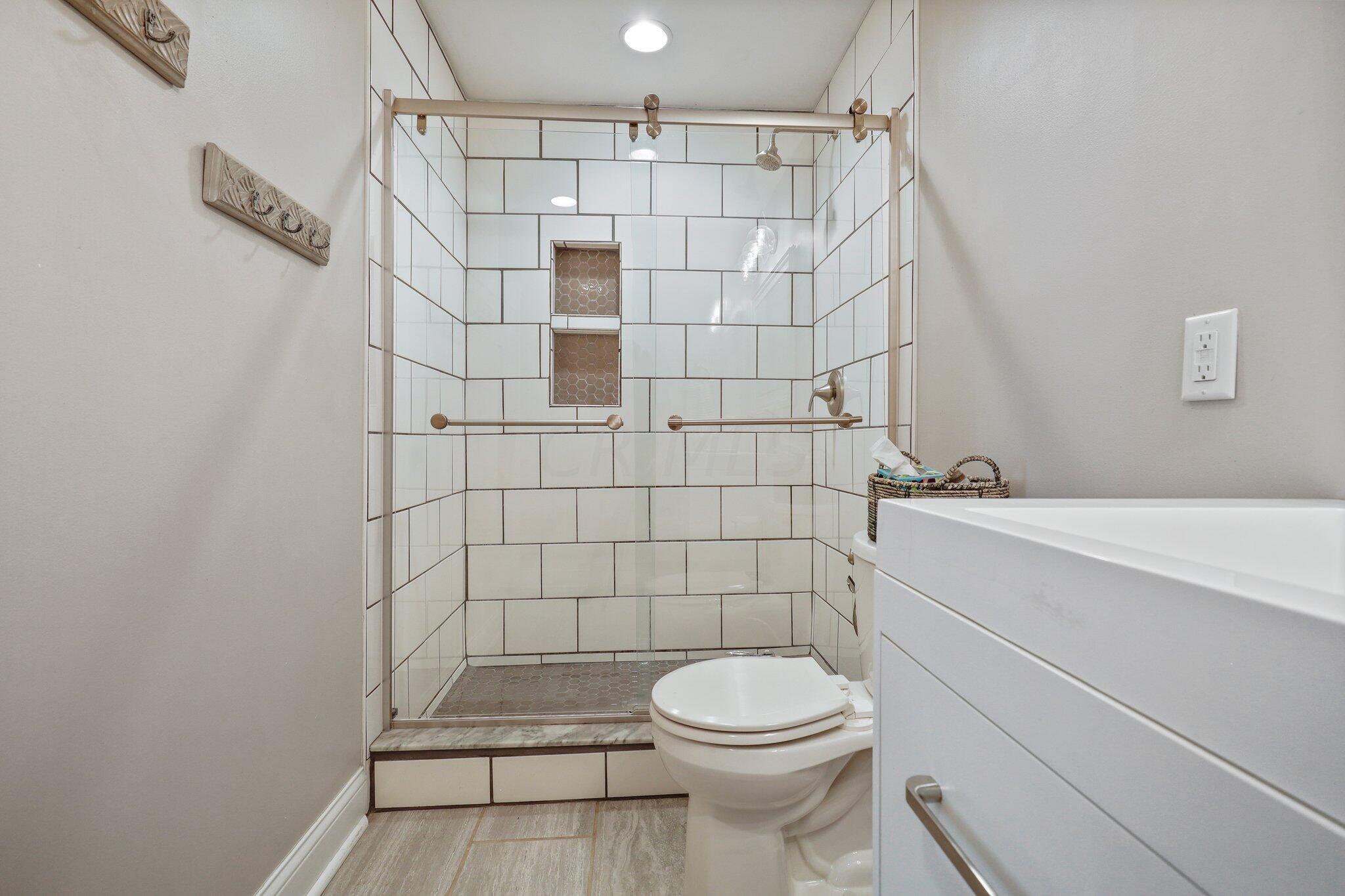 8200 Flint Road Columbus, OH 43235 - Photo 28 of 65 Tile walk-in shower w/ glass door