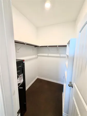 a bedroom with a bed chair and a chandelier