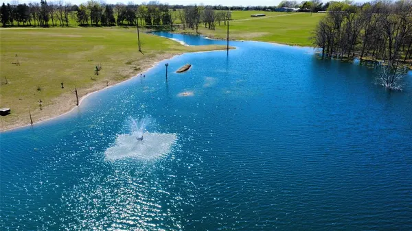 a view of a swimming pool with an outdoor seating and a yard