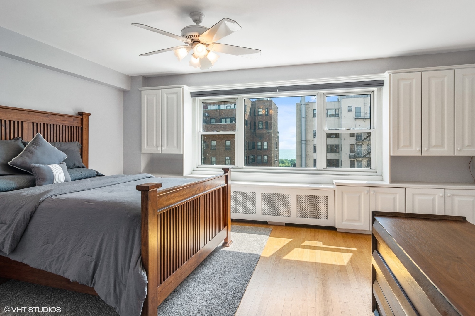 2909 North Sheridan Road, Unit 1402 Chicago, IL 60657 - Photo 11 of 15 a bedroom with a balcony a bed and a large window with the outer view