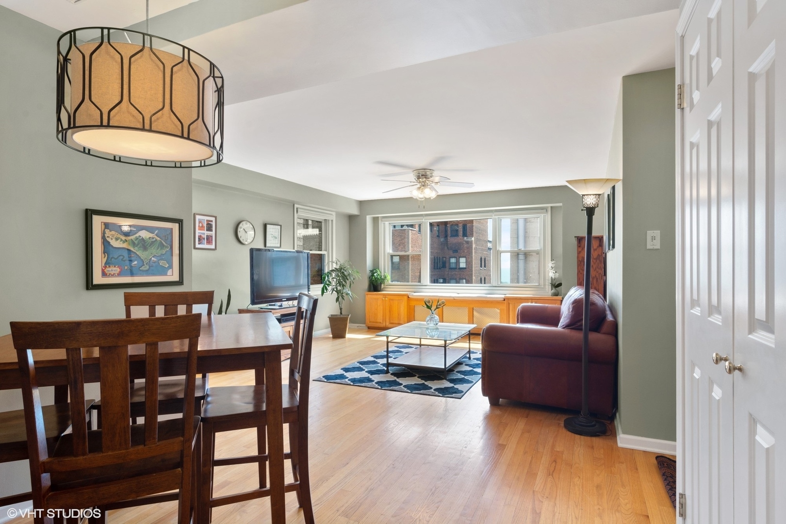 2909 North Sheridan Road, Unit 1402 Chicago, IL 60657 - Photo 6 of 15 a living room with furniture dining table and a window