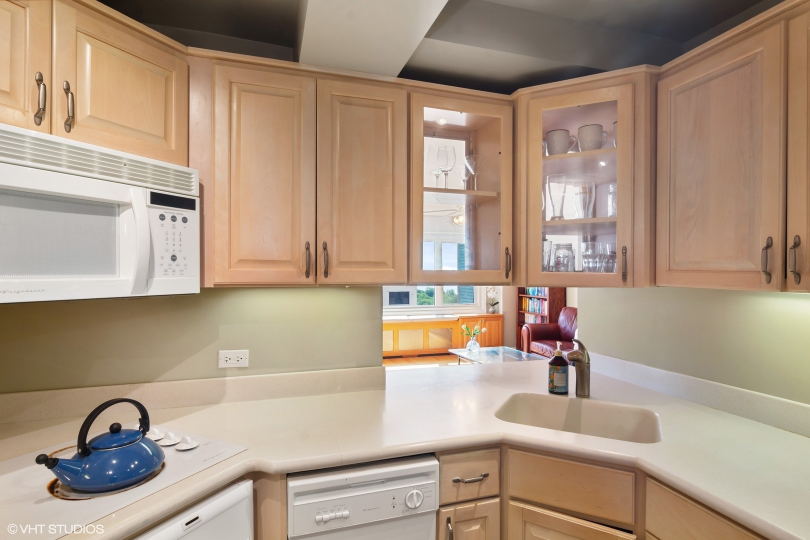 2909 North Sheridan Road, Unit 1402 Chicago, IL 60657 - Photo 8 of 15 a kitchen with sink a window and cabinets