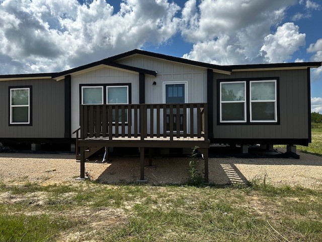 a view of house with yard and sitting area
