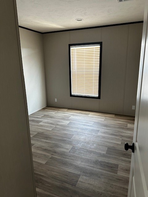 14318 Hughes Road Guy, TX 77444 - Photo 13 of 42 a view of an empty room with wooden floor and a window