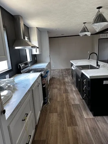 a kitchen with a sink and a stove top oven