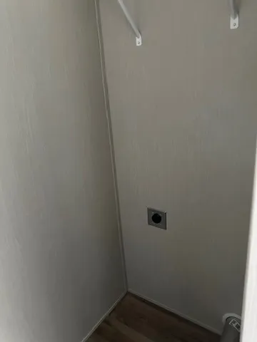 a bathroom with a granite countertop sink and white cabinets