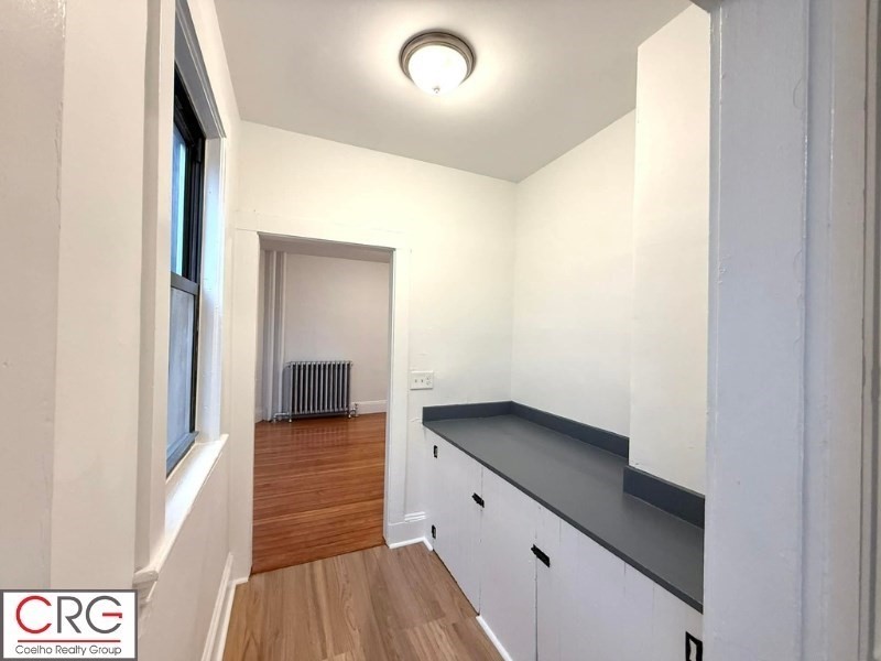 24 University Road, Unit 1 Brookline, MA 02446 - Photo 11 of 38 a kitchen with sink and cabinets