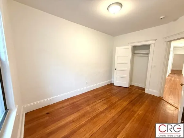 a view of an empty room and wooden floor