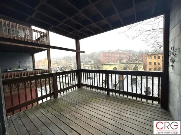 a view of porch with wooden floor