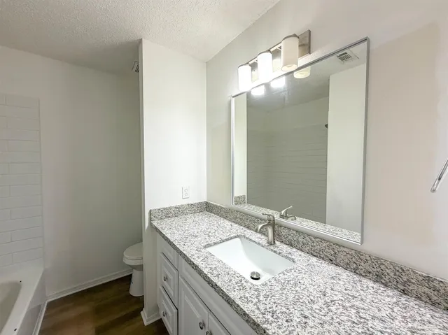 an empty room with a window and a ceiling fan