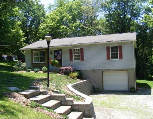 2031 Alamae Lakes Road Washington, PA 15301 - Photo 1 of 16 Exterior Front. Paver stone wall newly installed along with fresh landscaping gives this home a well loved appeal.