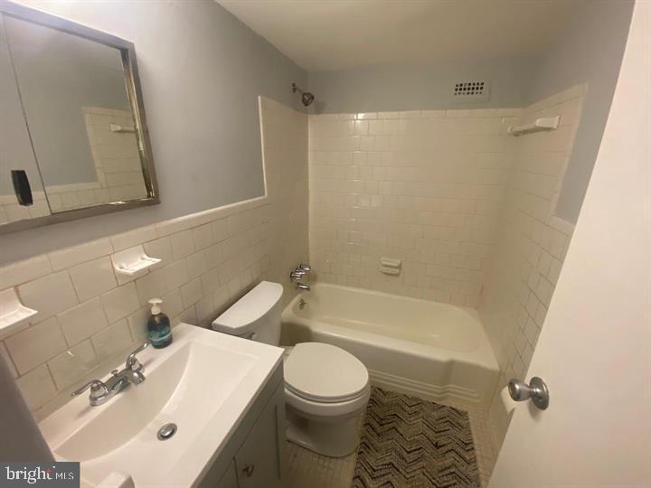 5801 Quantrell Avenue, Unit L9 Alexandria, VA 22312 - Photo 11 of 11 a bathroom with a sink toilet and shower