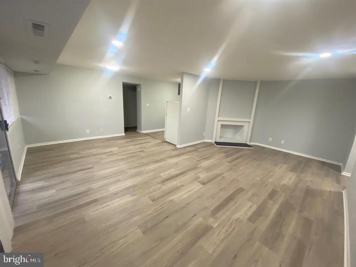 5801 Quantrell Avenue, Unit L9 Alexandria, VA 22312 - Photo 4 of 11 an empty room with wooden floor and windows