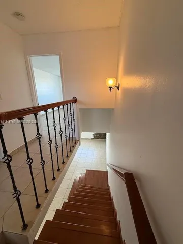 a large bedroom with a bed and a mirror