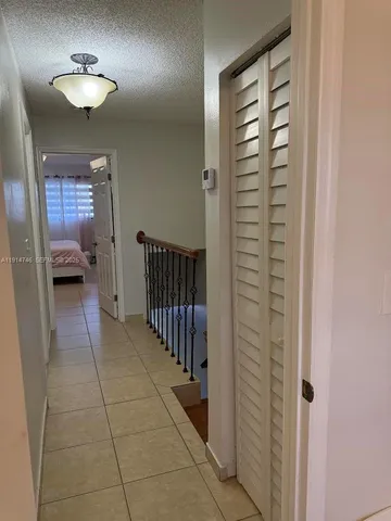 a view of a hallway to a livingroom with furniture