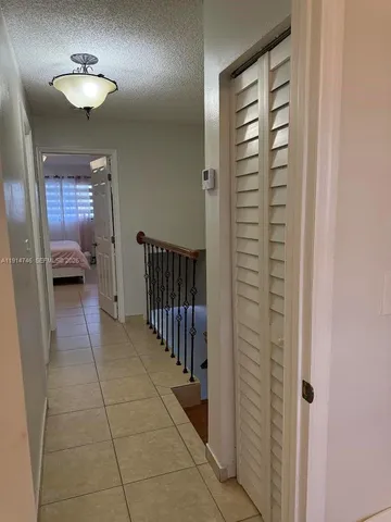 a spacious bedroom with a bed and a chandelier