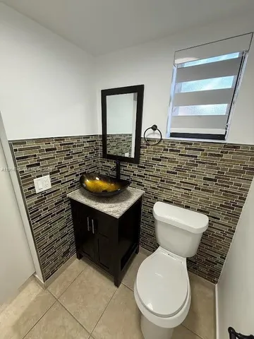 a kitchen with stainless steel appliances granite countertop a refrigerator a stove a sink and a microwave