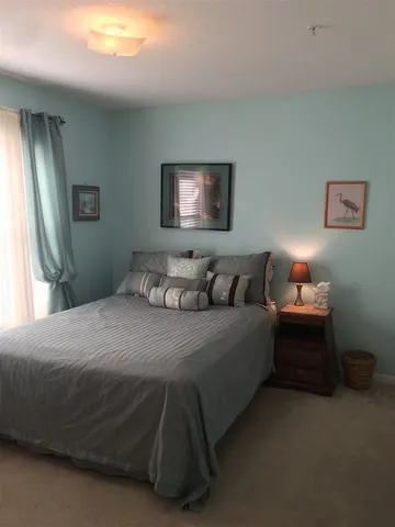 a bedroom with a bed and a lamp