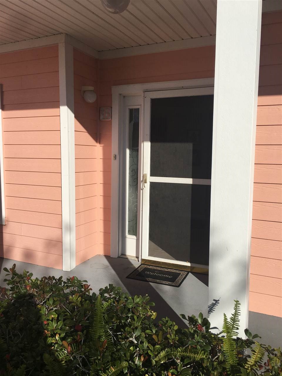 210 16th Street, Unit B St. Augustine, FL 32080 - Photo 2 of 12 a view of a small space with wooden wall and potted plants