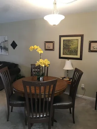 a dining room with furniture and chandelier