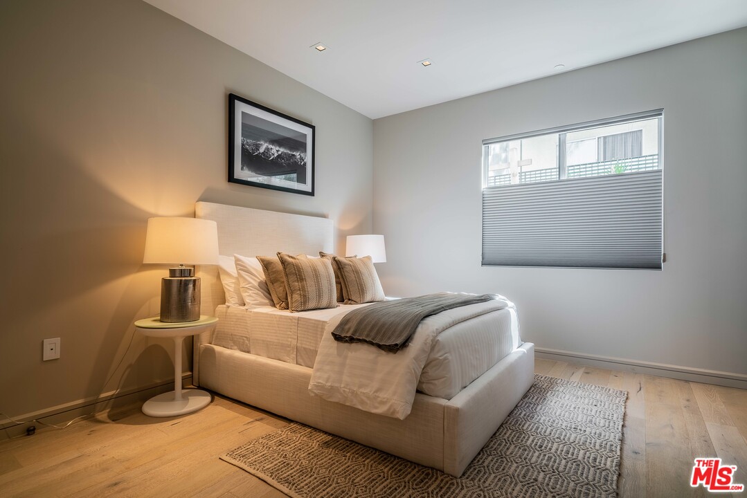 2391 Roscomare Road, Unit 103 Los Angeles, CA 90077 - Photo 12 of 32 a bed room with a bed and a window
