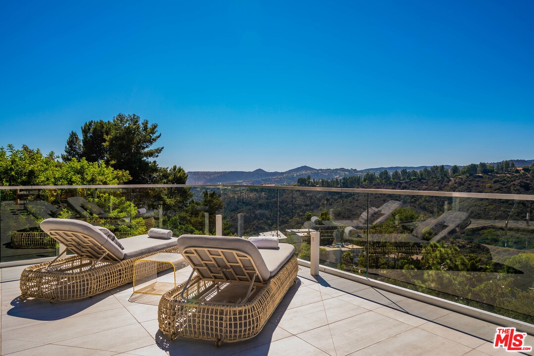 2391 Roscomare Road, Unit 103 Los Angeles, CA 90077 - Photo 23 of 32 a view of a roof deck with couches and sky view