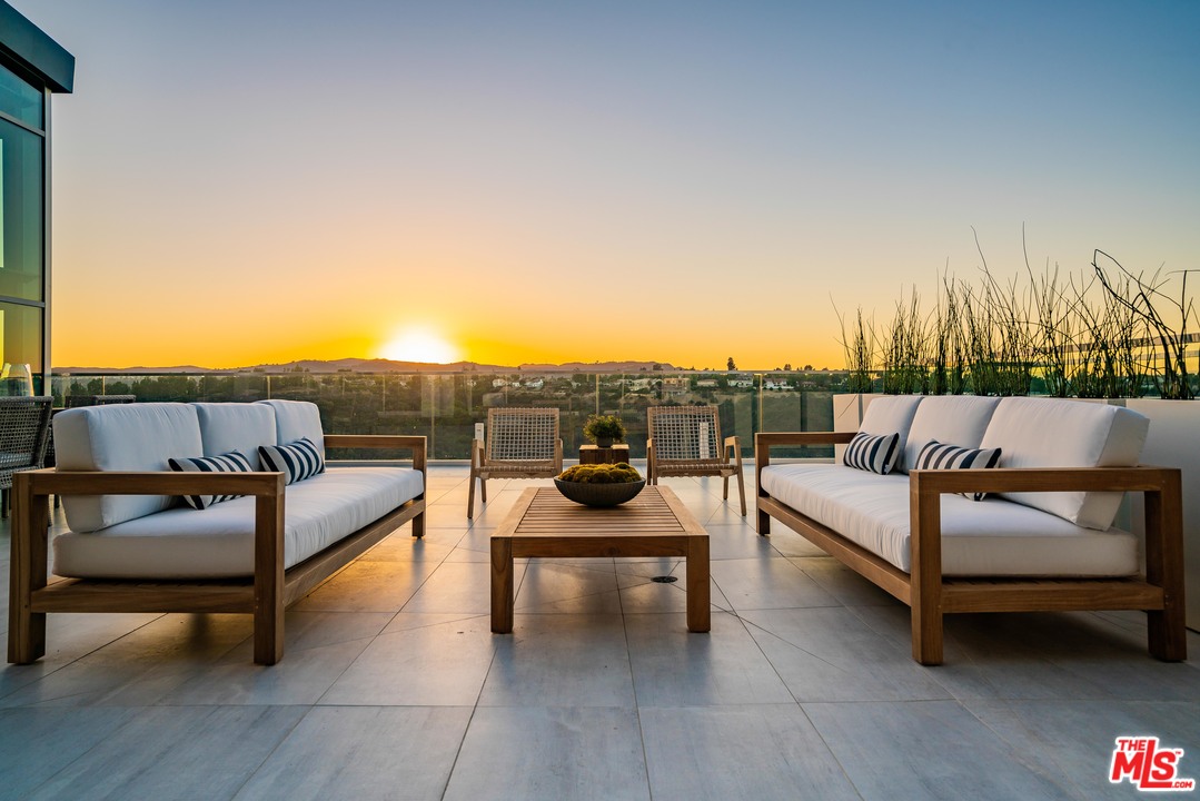2391 Roscomare Road, Unit 103 Los Angeles, CA 90077 - Photo 26 of 32 a view of a terrace with couches and sky view