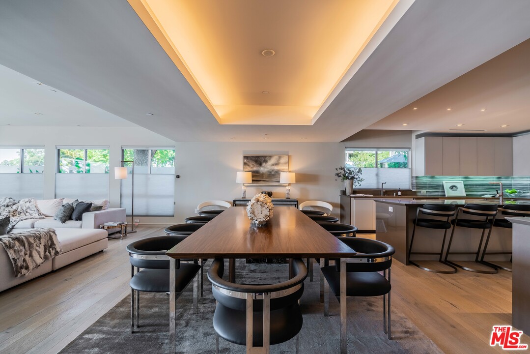2391 Roscomare Road, Unit 103 Los Angeles, CA 90077 - Photo 6 of 32 a living room with furniture a rug and a chandelier