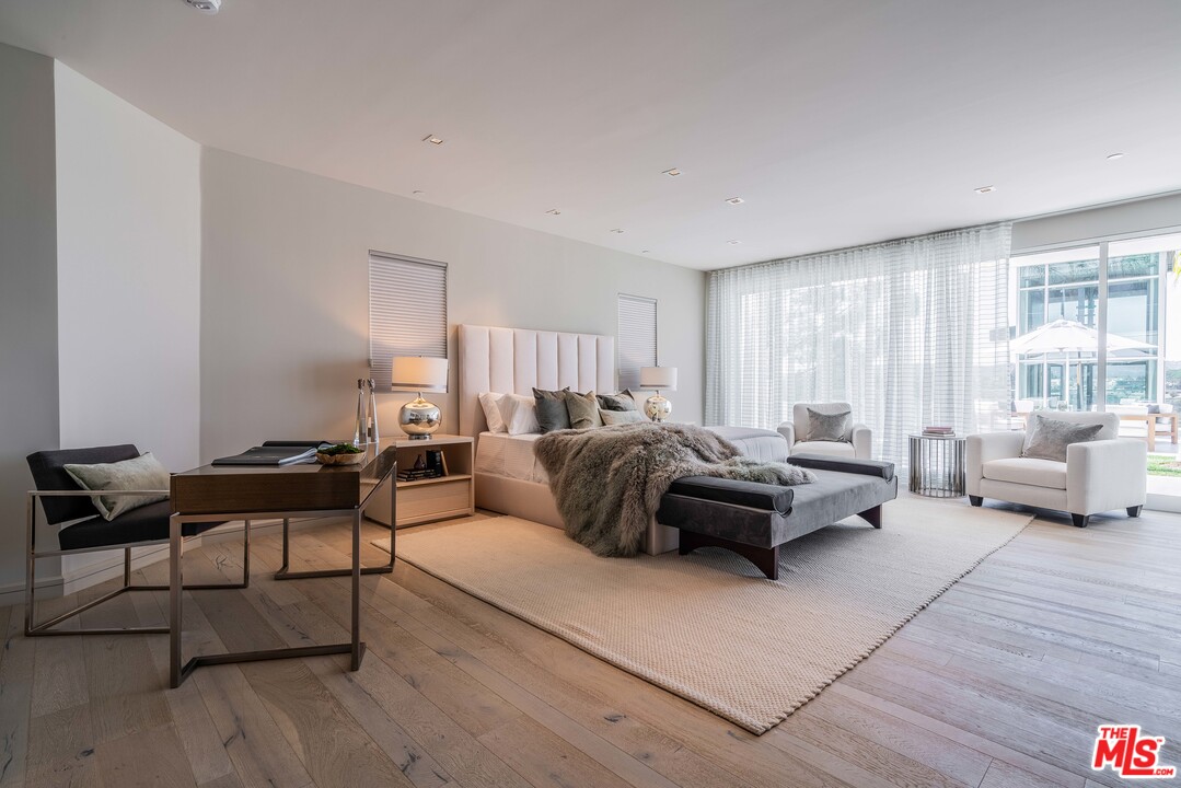 2391 Roscomare Road, Unit 103 Los Angeles, CA 90077 - Photo 8 of 32 a living room with furniture and a large window