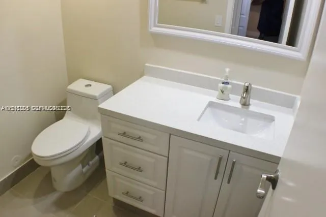 a close view of a sink and a toilet in the bathroom