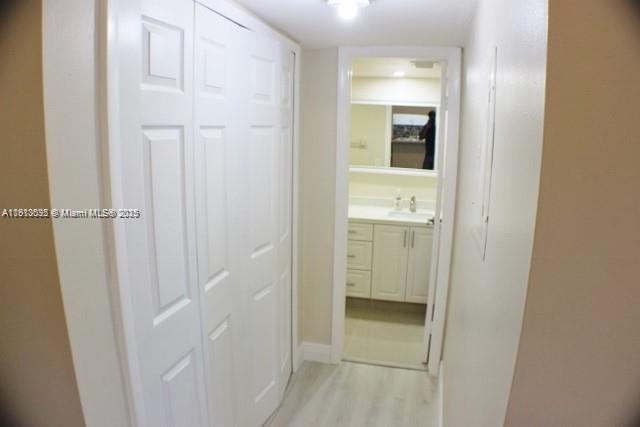 5975 Southwest 137th Avenue, Unit 803 Miami, FL 33183 - Photo 17 of 31 a view of a bathroom from a hallway