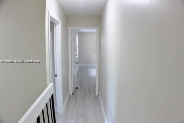5975 Southwest 137th Avenue, Unit 803 Miami, FL 33183 - Photo 20 of 31 a view of a hallway with wooden floor