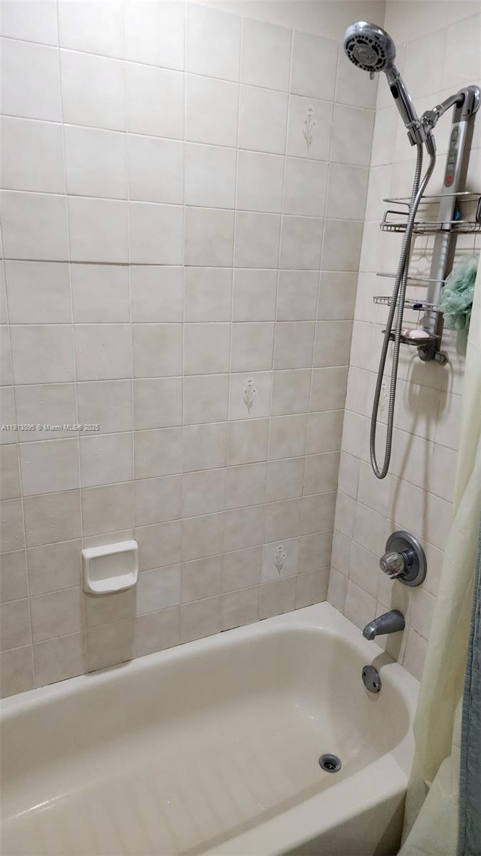 5975 Southwest 137th Avenue, Unit 803 Miami, FL 33183 - Photo 26 of 31 a bathroom with a bath tub and a shower