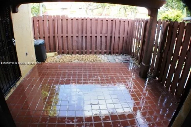 a view of a room with wooden floor and a wooden fence