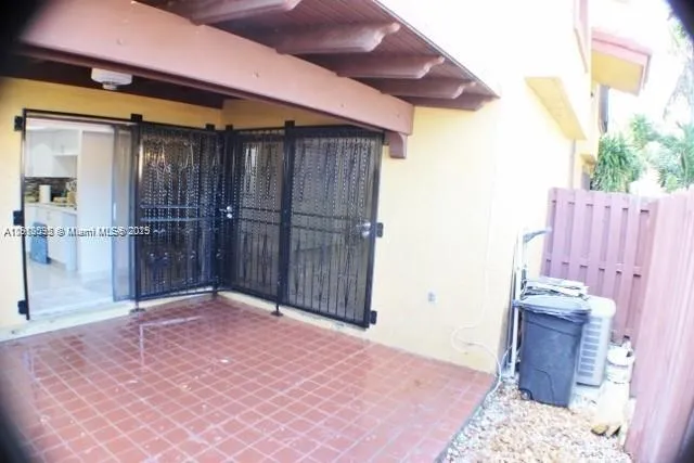 a view of a patio with iron fence