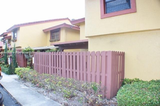 5975 Southwest 137th Avenue, Unit 803 Miami, FL 33183 - Photo 3 of 31 a view of a wooden fence