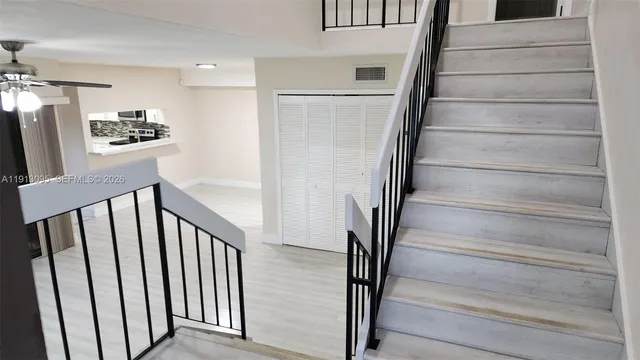 a view of staircase with lots of frames and a window