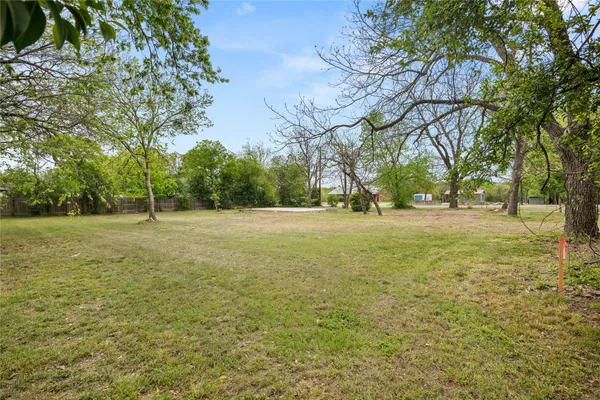 a backyard of apartments with large trees