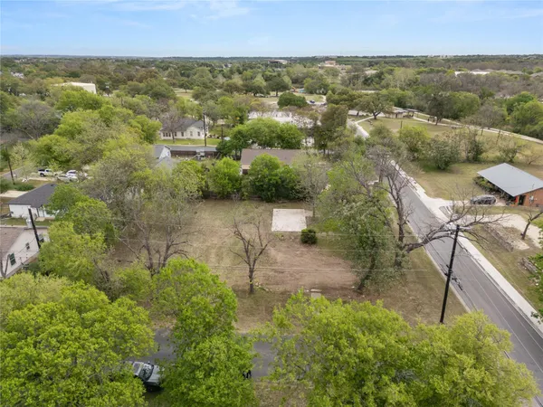 an aerial view of residential house with outdoor space and trees around