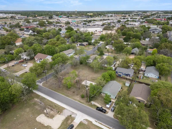 an aerial view of a houses with a yard