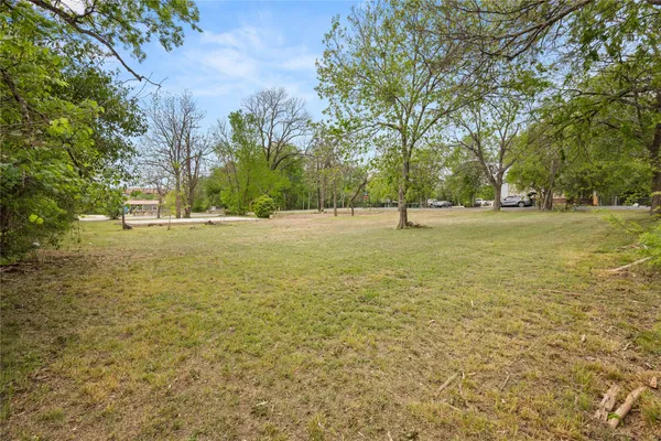 a view of outdoor space with trees all around